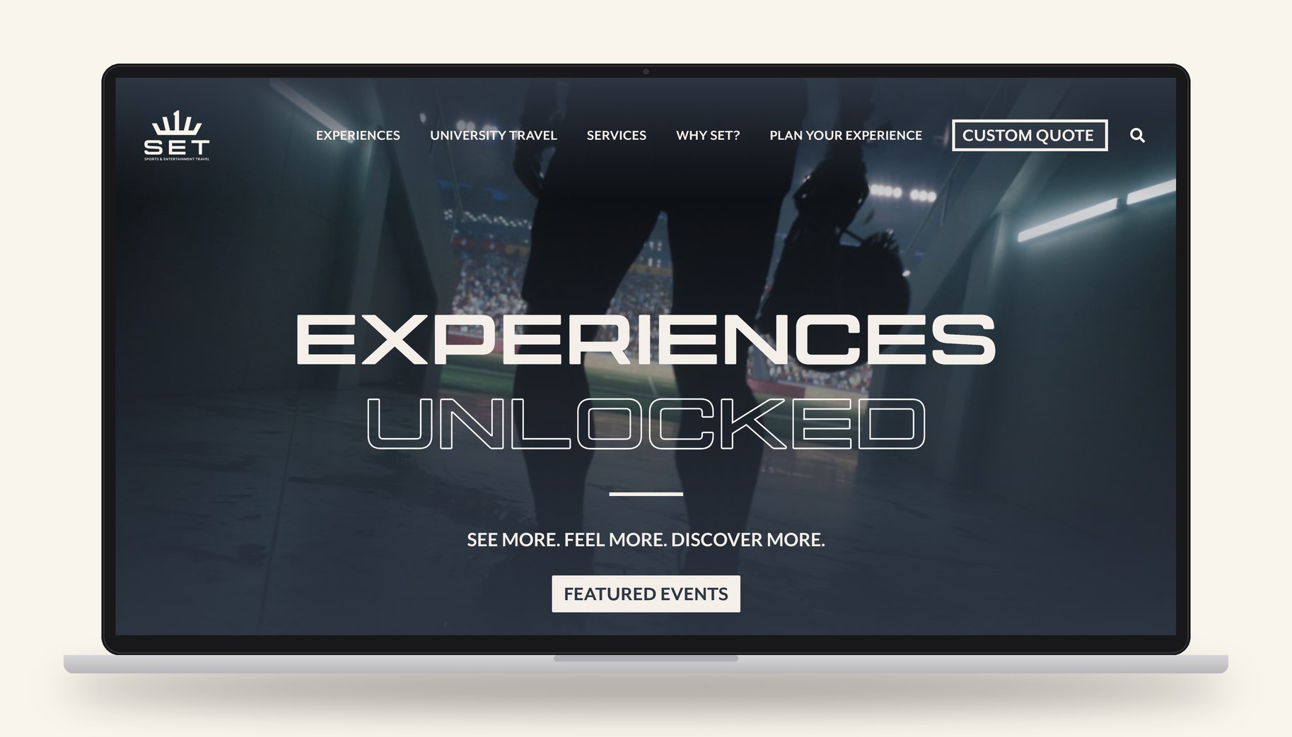 New SET website homepage on a laptop, reading Experiences Unlocked over a stadium tunnel